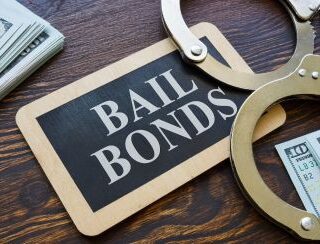 Bail bonds sign with handcuffs and cash in Liberty