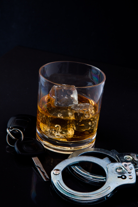 Whiskey glass and handcuffs for DWI bail bonds in Madisonville