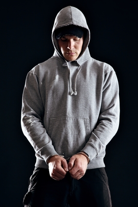 Handcuffed man in a hoodie needing a bail bond in Liberty