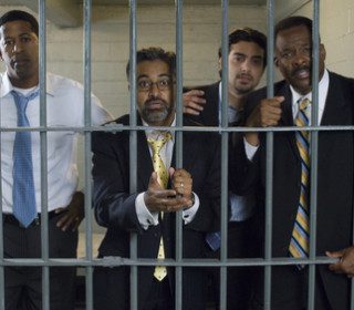 Men in suits behind jail bars needing misdemeanor bail bonds in Austin
