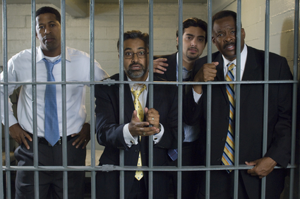 Men in suits behind jail bars needing misdemeanor bail bonds in Liberty
