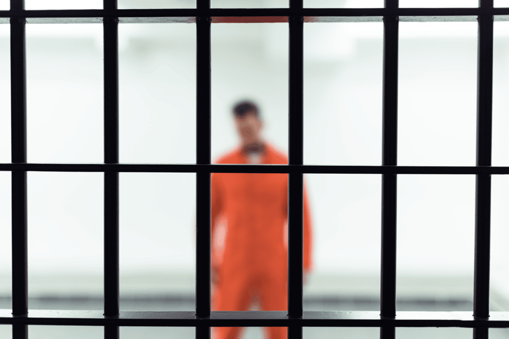 Inmate behind jail bars waiting for bail in Fort Worth