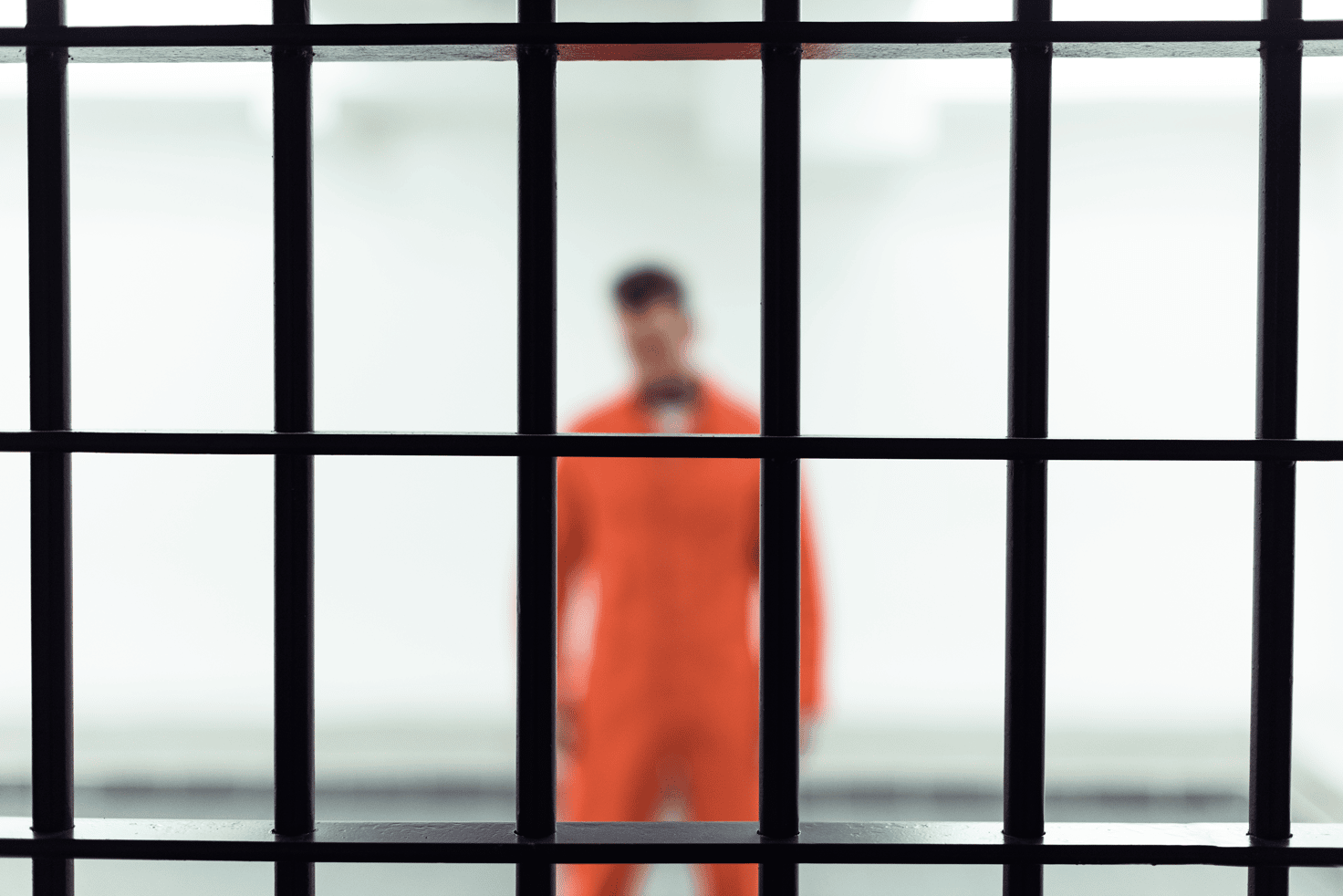Inmate behind jail bars waiting for a bail bondsman in Fort Worth