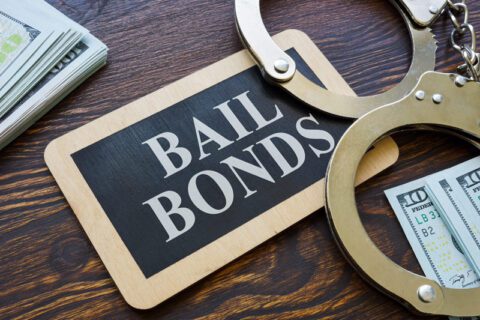 Bail bonds sign with handcuffs and cash in Gulfgate