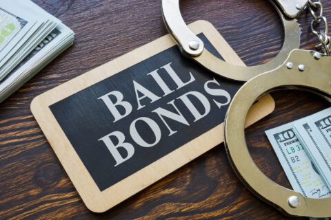 Bail bonds sign with handcuffs and cash in North Houston