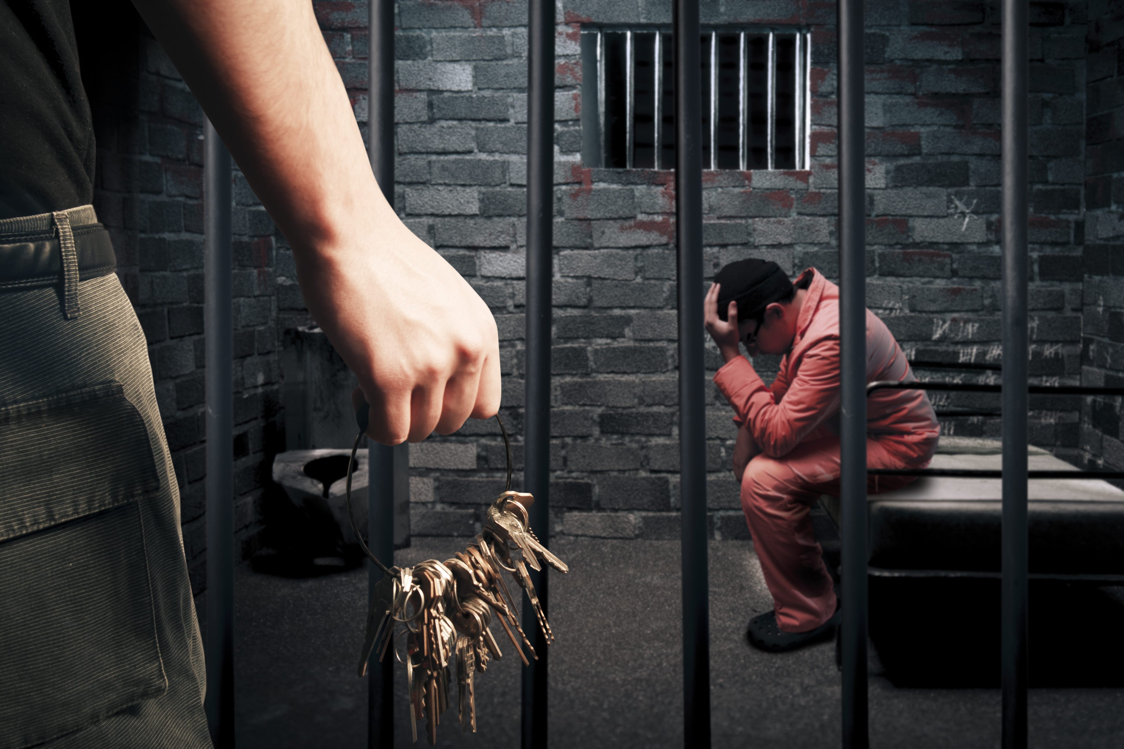 Guard unlocking a jail cell for release by a bail bondsman in Harris County