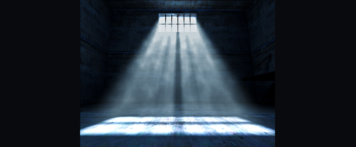 Light shining into a dark jail cell for bail bonds in Humble