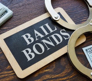 Bail bonds sign with handcuffs and cash for cheap bail bonds in Liberty