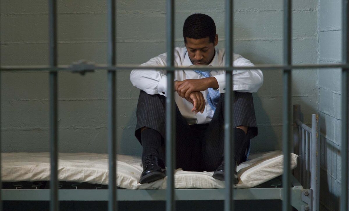 Man in a jail cell waiting for a local bail bondsman in Fort Bend County
